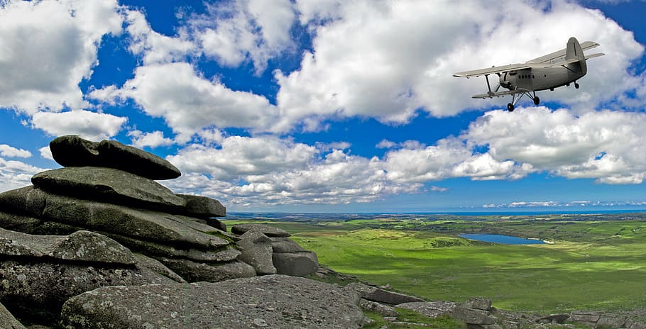 gray, biplane, midair, rock outcrop, landscape, cloudy sky, outcrop, scenic, rocks, rocky