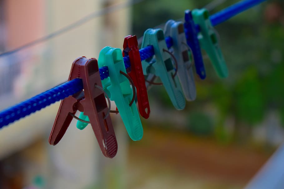 clothespins, tweezers, array of clips, hanging, focus on foreground, multi colored, close-up, clothespin, clothesline, rope
