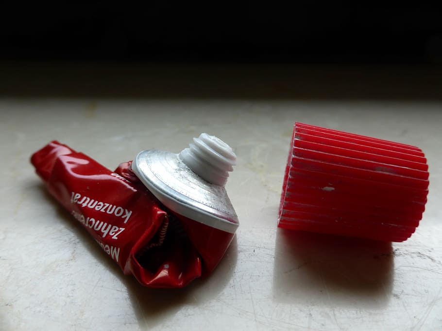 red, toothpaste tube container, plastic cap, tube, toothpaste, aluminium, empty, depleted, depressed, rolled