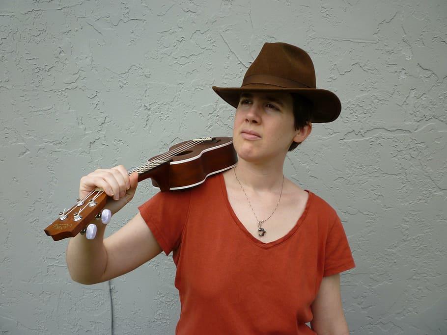 ukulele, hat, squint, musician, musical instrument, music, one person, clothing, wall - building feature, string instrument