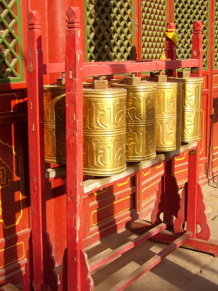 brass-colored prayer wheel, stand, mantra, monastery, tibet, china, temple, red, indoors, day