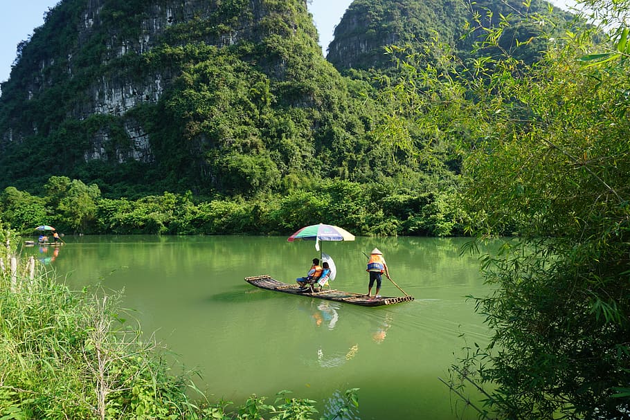 yulong river, boat, bamboo raft, water, tree, real people, plant, nautical vessel, men, day