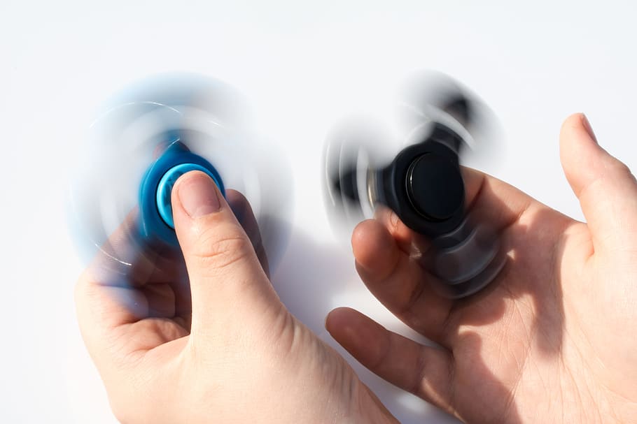 fidget spinner, spinner, Fidget, Spinner, fidget spinner, two fidget spinner, toys, in rotation, on the index finger lying, on the index finger turning, between the thumb and index finger