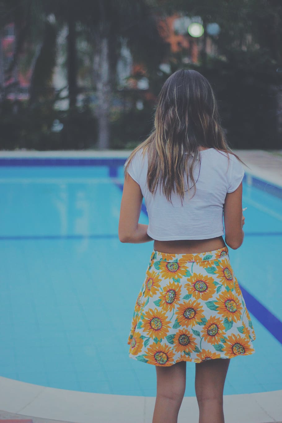 woman, standing, pool, blonde, haired, white, crop, top, yellow, floral