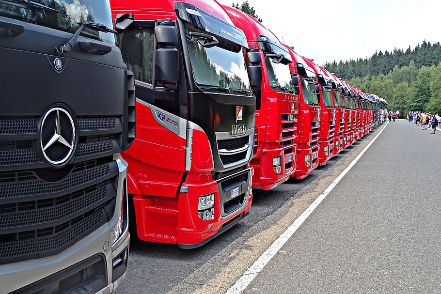 lined trucks, truck, formula 1, mercedes, red, transportation, mode of transportation, land vehicle, road, day