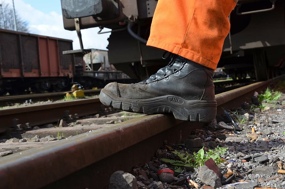 person, wearing, black, leather combat boot, stepping, train track, work shoes, rail, track, seemed head