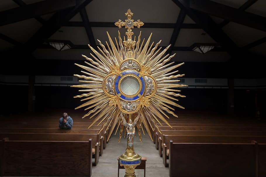 gold-colored crucifix cathedral decor, brown, blue, church, relic, dark, people, praying, man, monstrance