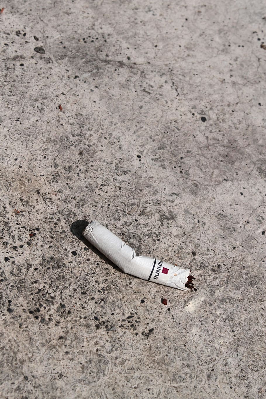 cigarette butts, concrete floor, litter anywhere, high angle view, cigarette, day, bad habit, cigarette butt, social issues, single object