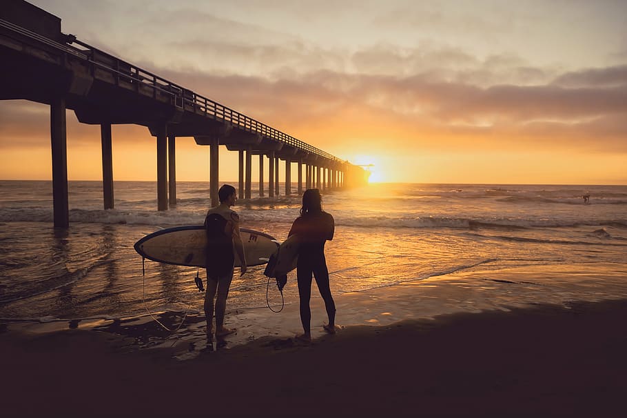 two, surfers, standing, beach, dock, person, barefoot, seashore, holding, surf