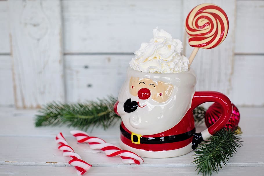closeup, santa claus cup, hot chocolate, santa mug, peppermints, candy canes, christmas, white space, text space, border