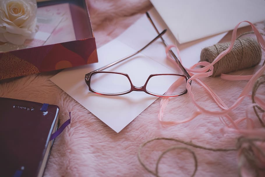 brown framed eyeglasses, arts and crafts, blanket, book, box, color, envelope, fashion, flower, indoors
