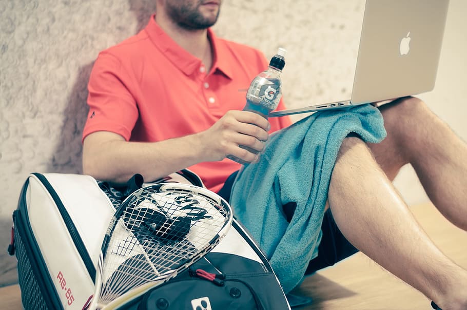 man, sitting, brown, wooden, surface, holding, gatorade plastic bottle, squash, sport, game