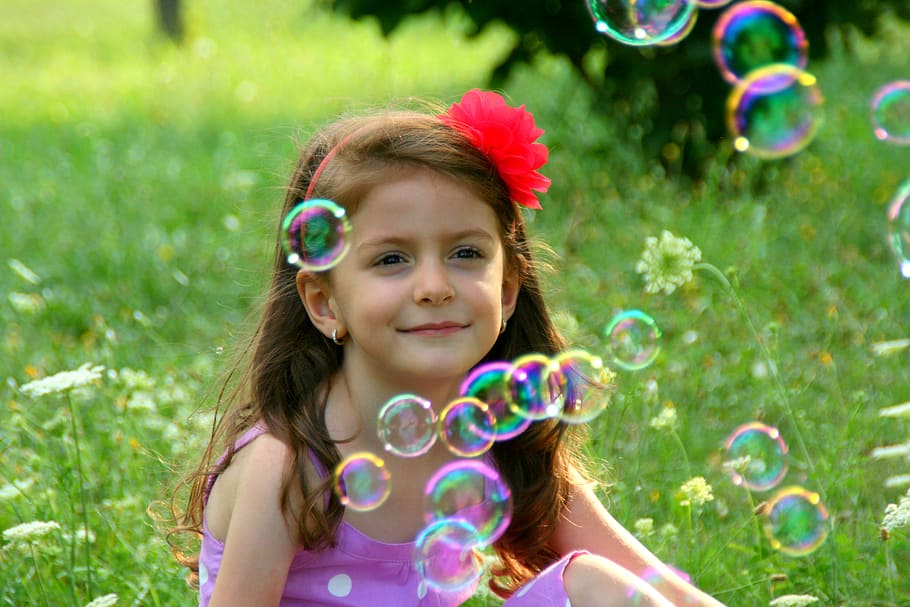 selective, focus photography, girl, sitting, green, grass, soap bubbles, smile, bubbles, portrait