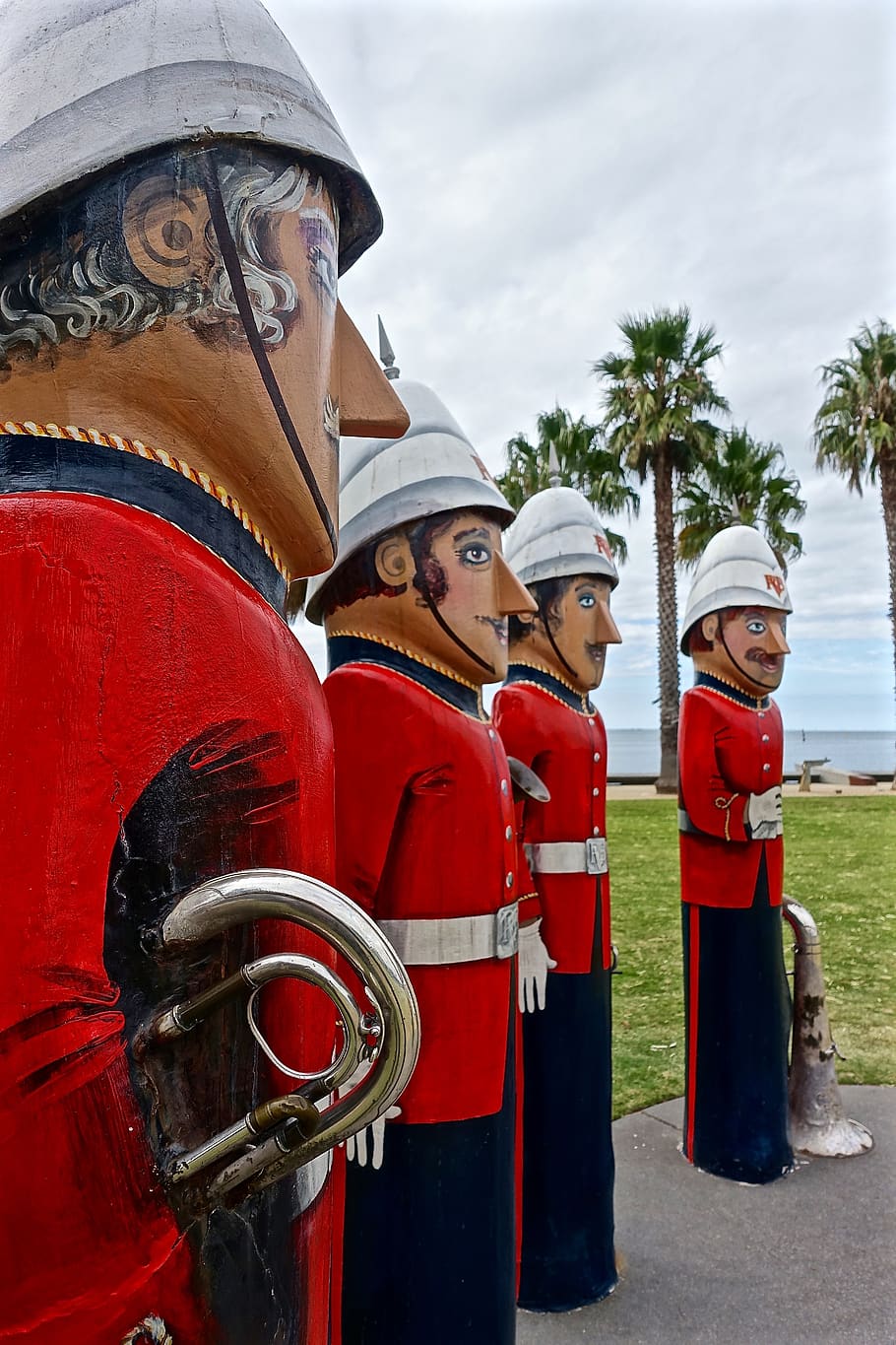 statues, musicians, brass band, totem poles, figures, military, sculpture, red, day, representation
