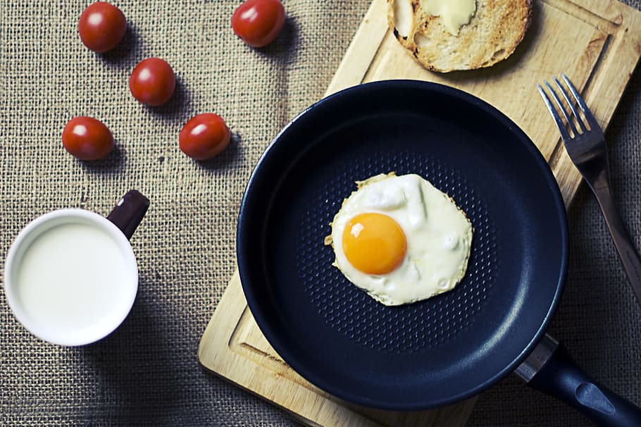 sunny, side, frying, pan, stainless, steel fork, breakfast, eggs, cutting board, bread