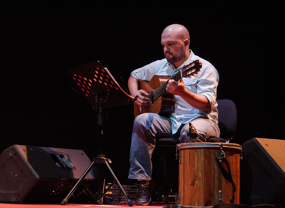 concert, guitar, guiarra venezuelan, musical instrument, adult, one person, music, sitting, musician, arts culture and entertainment
