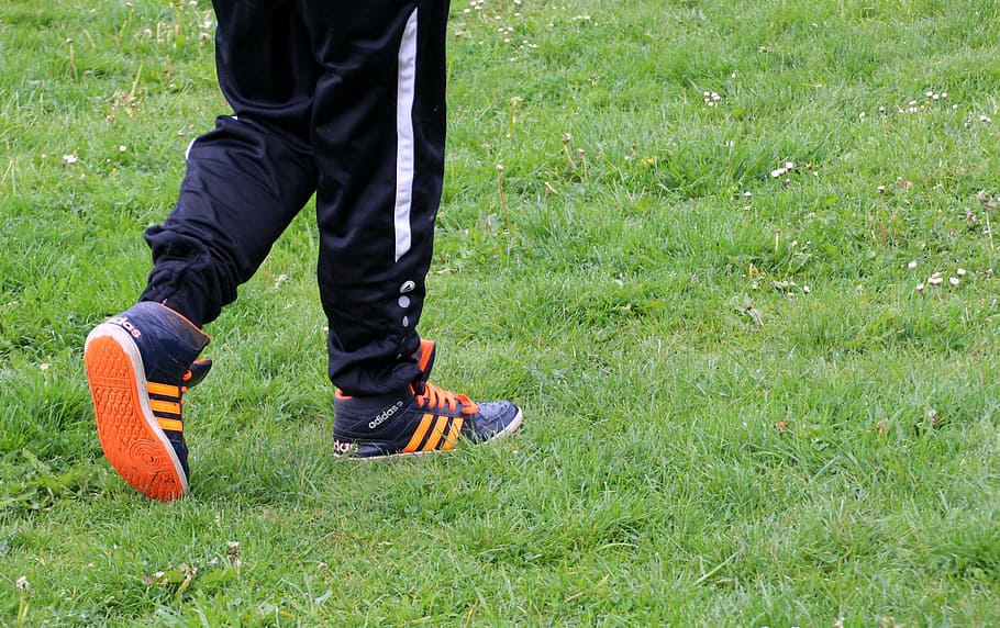 person, wearing, black, track pants, adidas sneakers, walking, grass, go, run, shoes