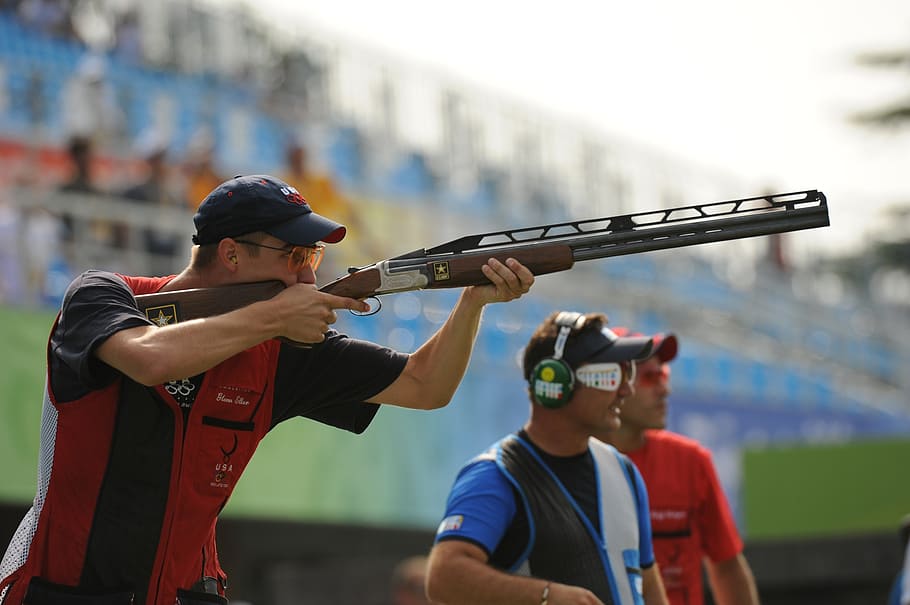 man holding shotgun, shooter, shooting, gun, rifle, trap, olympics, competition, accuracy, aim