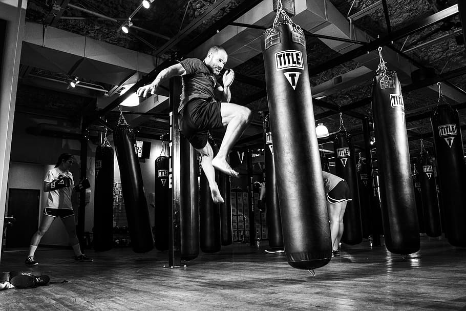 grayscale photo, man, kicking, black, title, heavy, bag, karate, martial arts, training