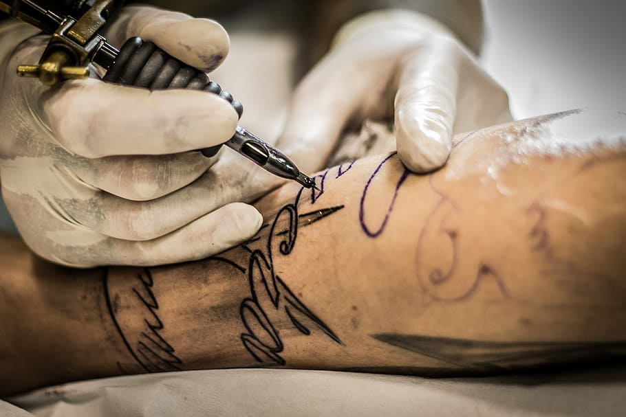 person, holding, black, gold tattoo machine, tattoo, hand, man, adult, art, male
