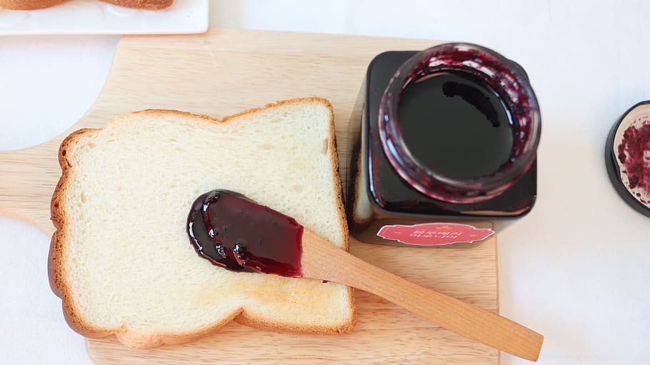 bread, jam, blueberry jam, food and drink, indoors, food, cutting board, freshness, table, still life