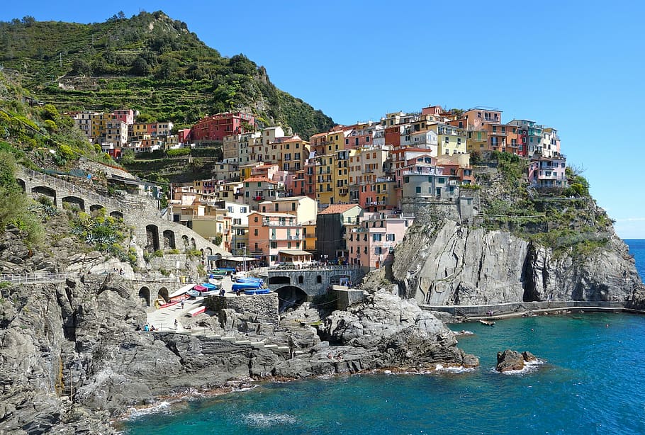 assorted-color, concrete, houses, daytime, italy, manarola, liguria, rock, sea, mediterranean
