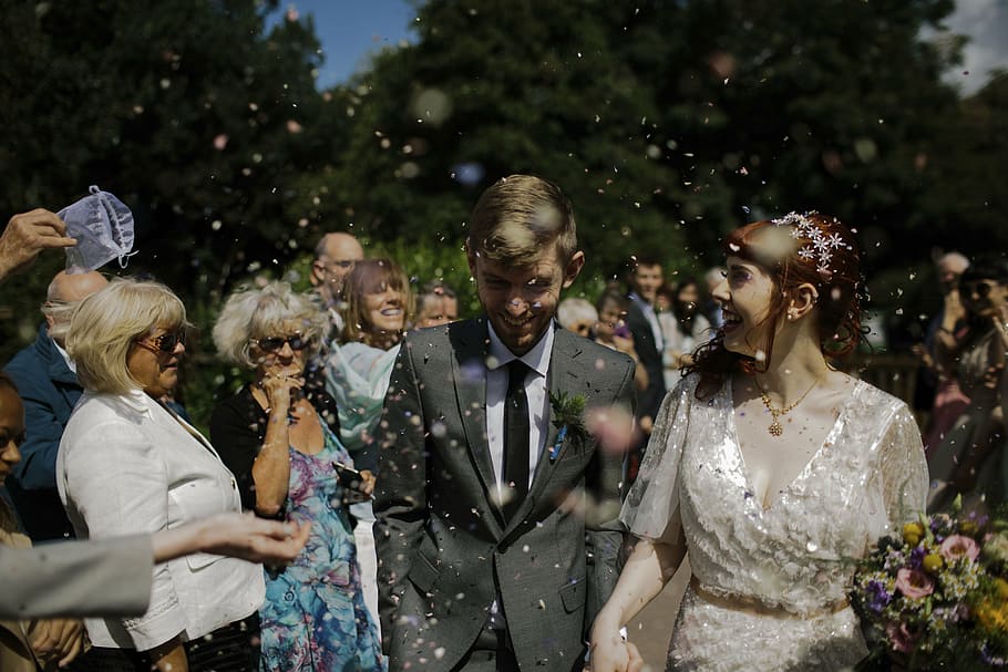 smiling, bride, groom, surrounded, guests, daytime, people, man, woman, wedding