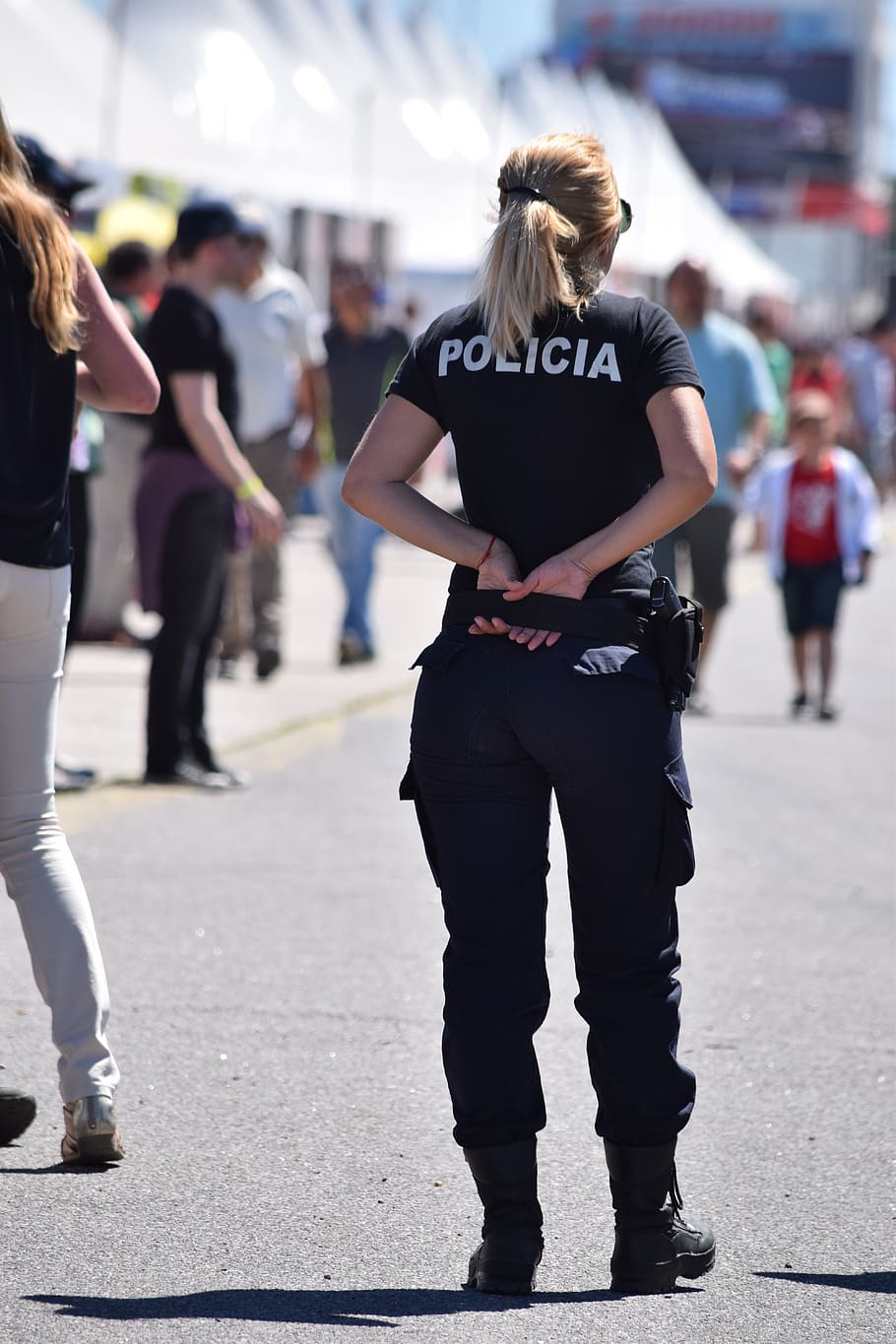 police, sexy woman, girl, pretty, real people, city, incidental people, focus on foreground, street, rear view