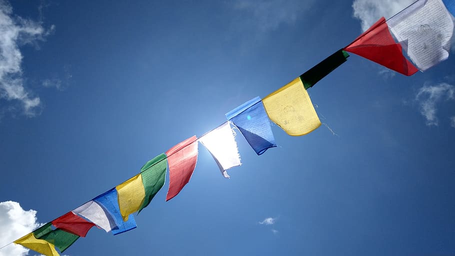 assorted-color flags, tibetan buddhism, nepal, colored flag, sky, flag, multi colored, patriotism, low angle view, nature