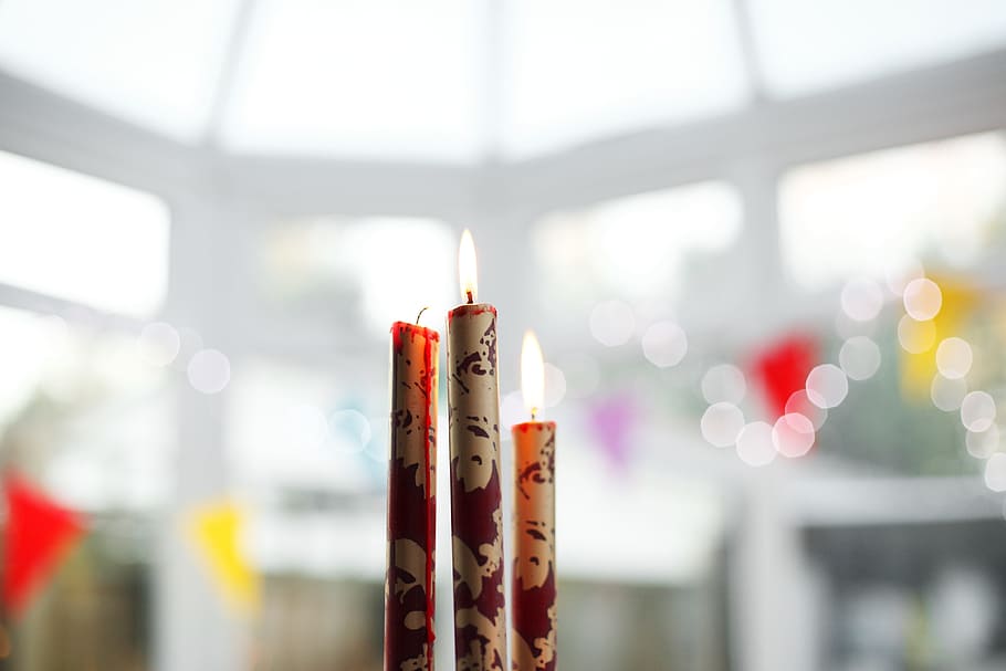 selective, focus photography, three, white-and-red, lighted, stick, candles, flame, candlelight, light
