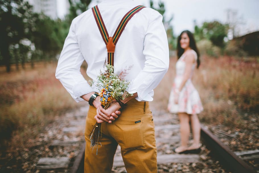 man, holding, flowers, front, woman, daytime, nature, love, couple in love, grooms