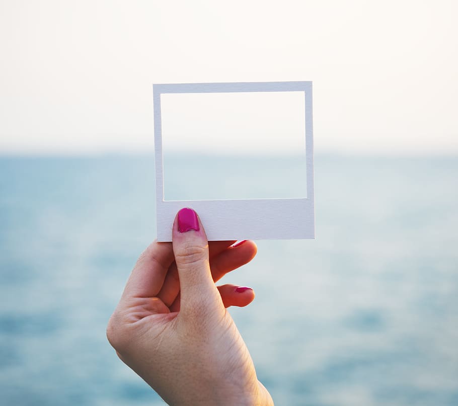 person, hand, holding, white, square paper frame, shore, craft, paper, tranquil scene, ocean