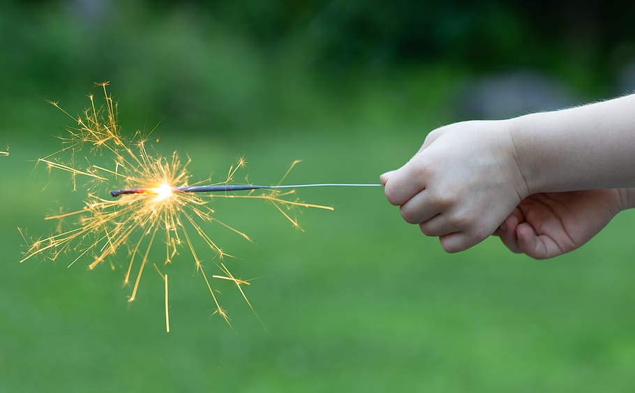 sparklers, fireworks, holiday, celebration, party, outdoors, hands, holding, sparks, bokeh