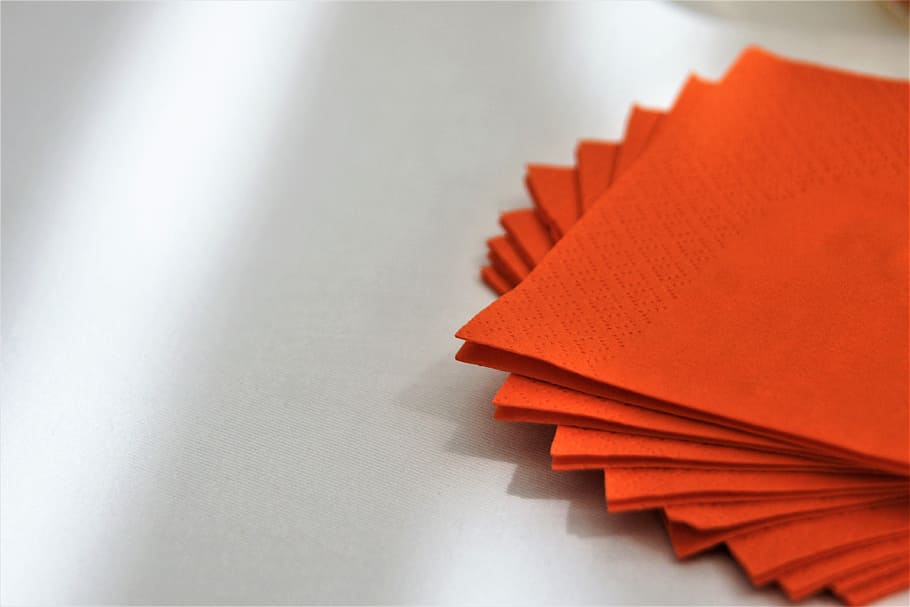 red papers, orange, color, napkin, paper, stack, table, red, indoors, close-up