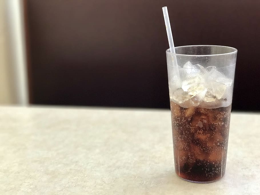 clear, plastic drinking cup, half-filled, black, liquid, ice, white, wooden, table, Soda, Glass