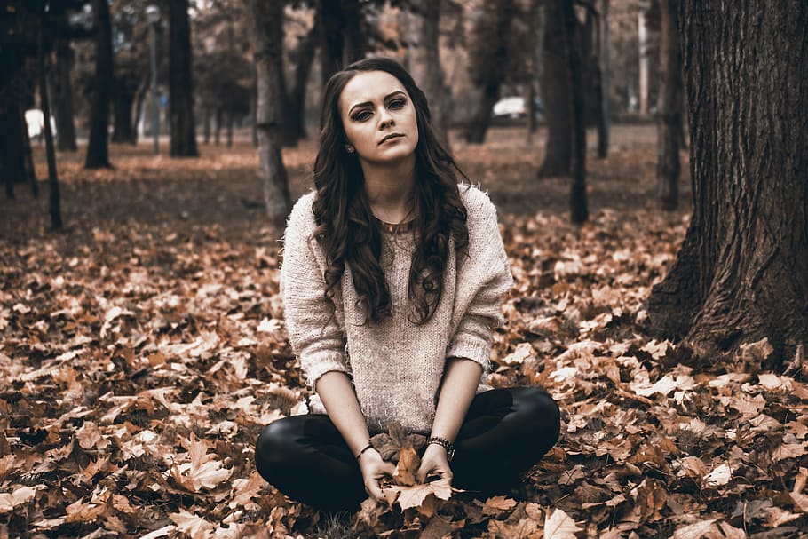 woman, gray, sweater, black, pants, sitting, ground, full, leaves, sadness