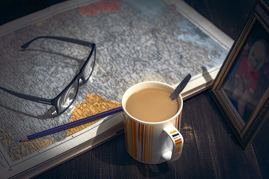 coffee, table, book, pen, drink, mug, map, cup, brown, read