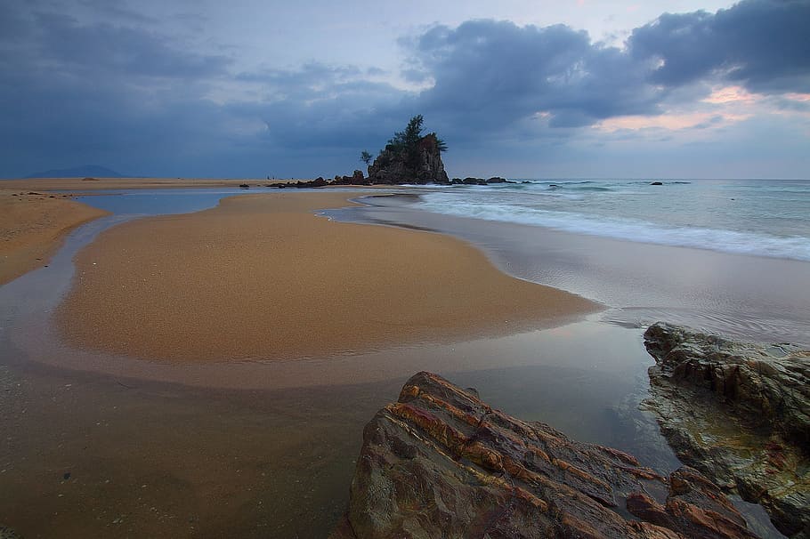 island center body, water, seascape, storm, landmark, land, sea, beach, sky, beauty in nature