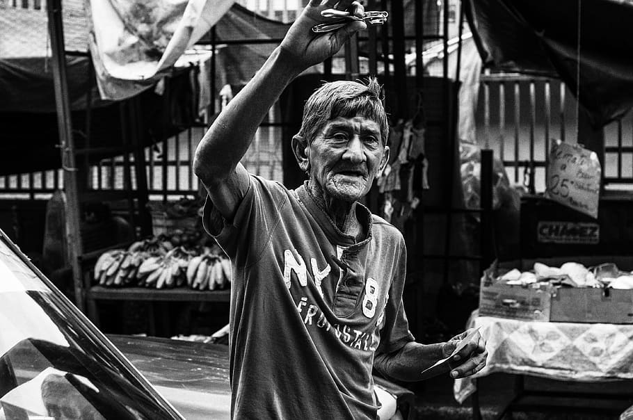 grayscale photo, man, wearing, polo shirt, market, maracaibo, venezuela, selling razors, black and white, outside