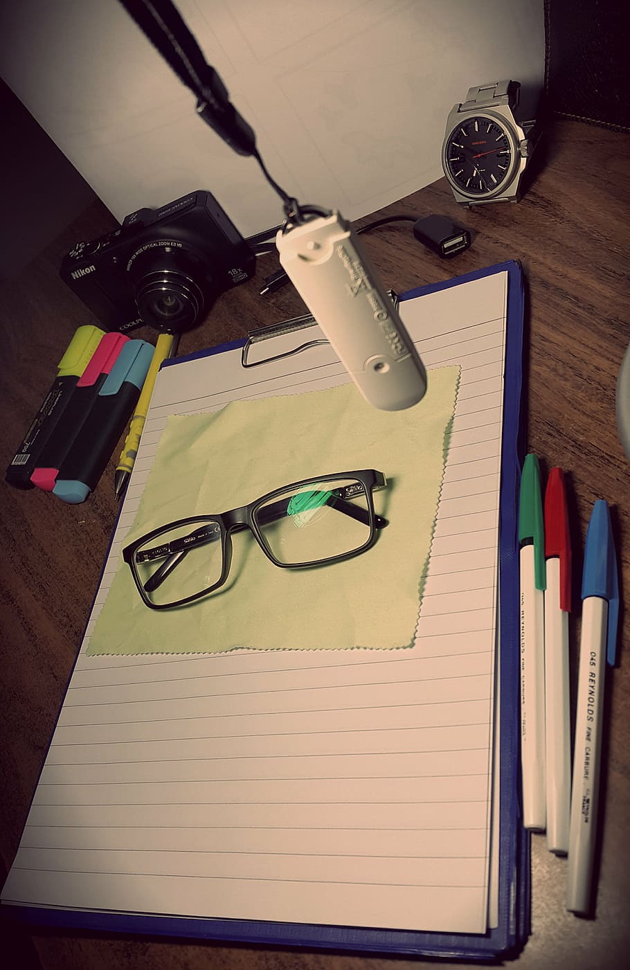 lifestyle, study, camera, glasses, table, pen, eyeglasses, indoors, high angle view, writing instrument