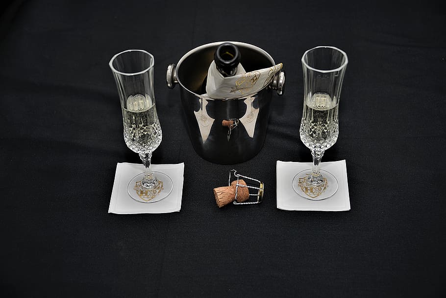 two, white, flute glasses, opened, bottle, ice bucket, bottle of sparkling wine, glasses, cork, drink