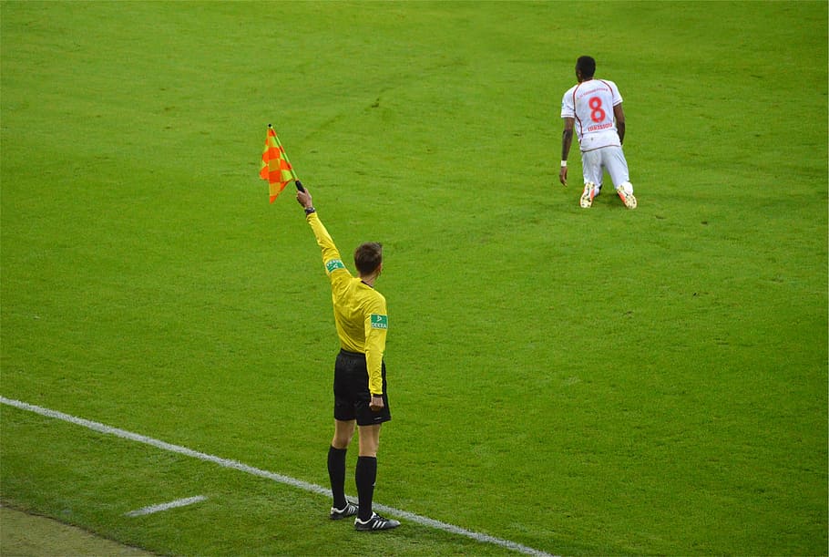 soccer referee, raising, yellow, flag, soccer, referee, holding, orange, stripe, field