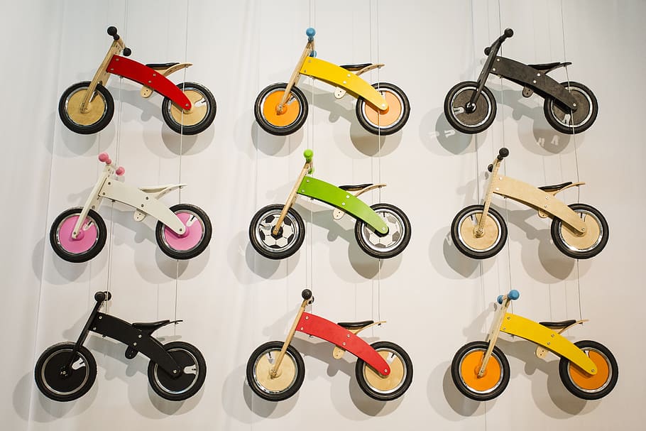 nine, assorted-color balance bike miniatures, impeller, wheels, children, drive, wall, small child, mountain bike, still life
