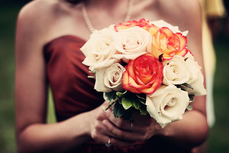 woman, brown, tube, top, holding, white, red, petaled flowers, bouquet, bouquet of flowers