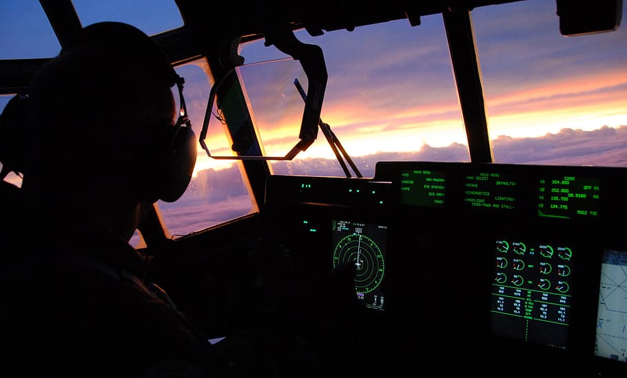 person driving airplane, sunset, sky, clouds, aircraft, cockpit, cockpit view, up close, pilot, military