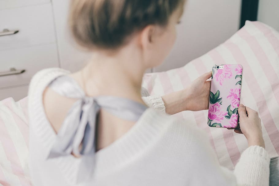 woman, holding, pink, floral, flip, case, people, iphone, apple, bed