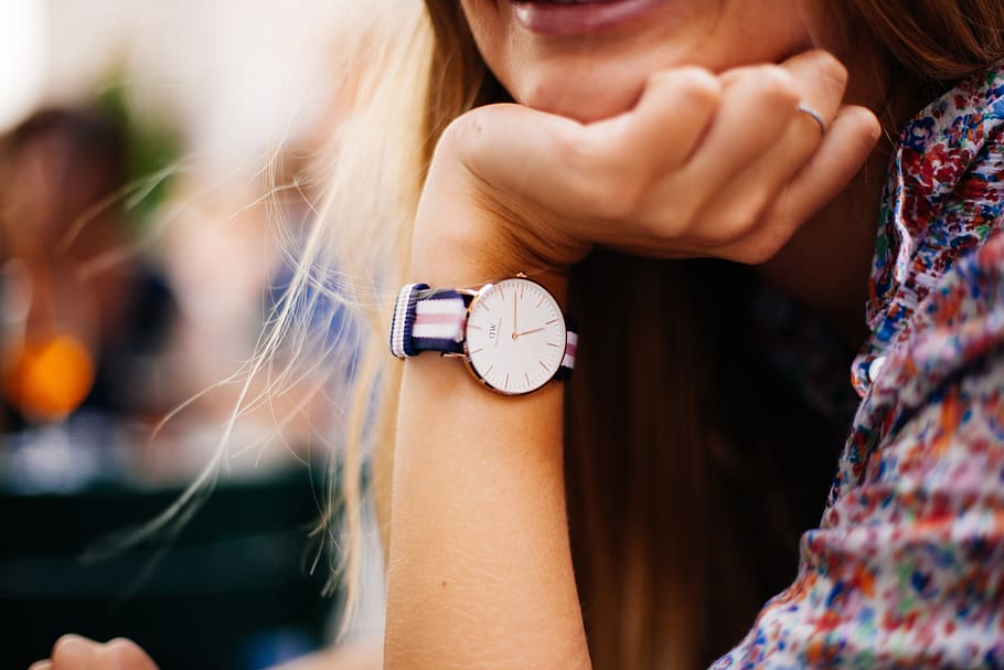 woman, wearing, round gold-colored analog, watch, white-red-and-blue, striped, strap, timepiece, wrist, hand