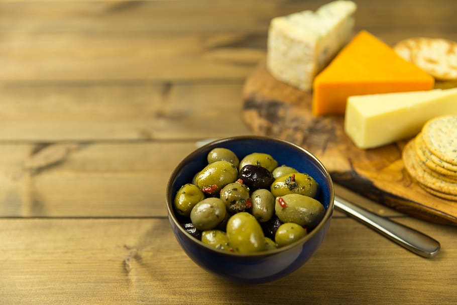 olives, cheese, crackers, table, wood, spoon, bowl, food, snack, food and drink