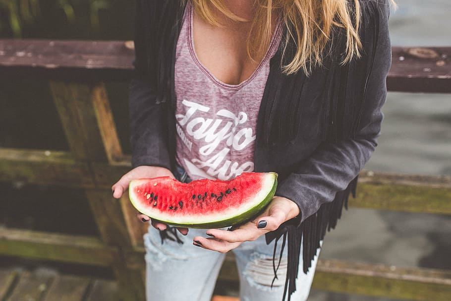 person, standing, holding, sliced, watermelon, woman, black, jacket, slice, girl