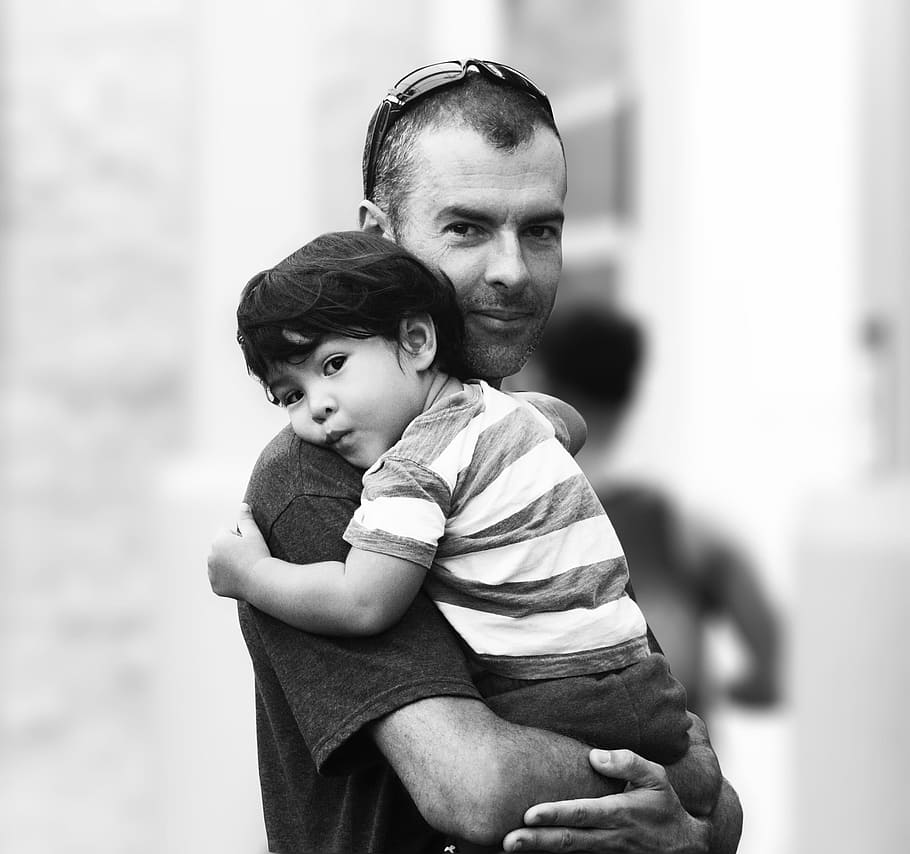 grayscale photography, man, carrying, baby, family, uncle, familia, nephew, child, on arms